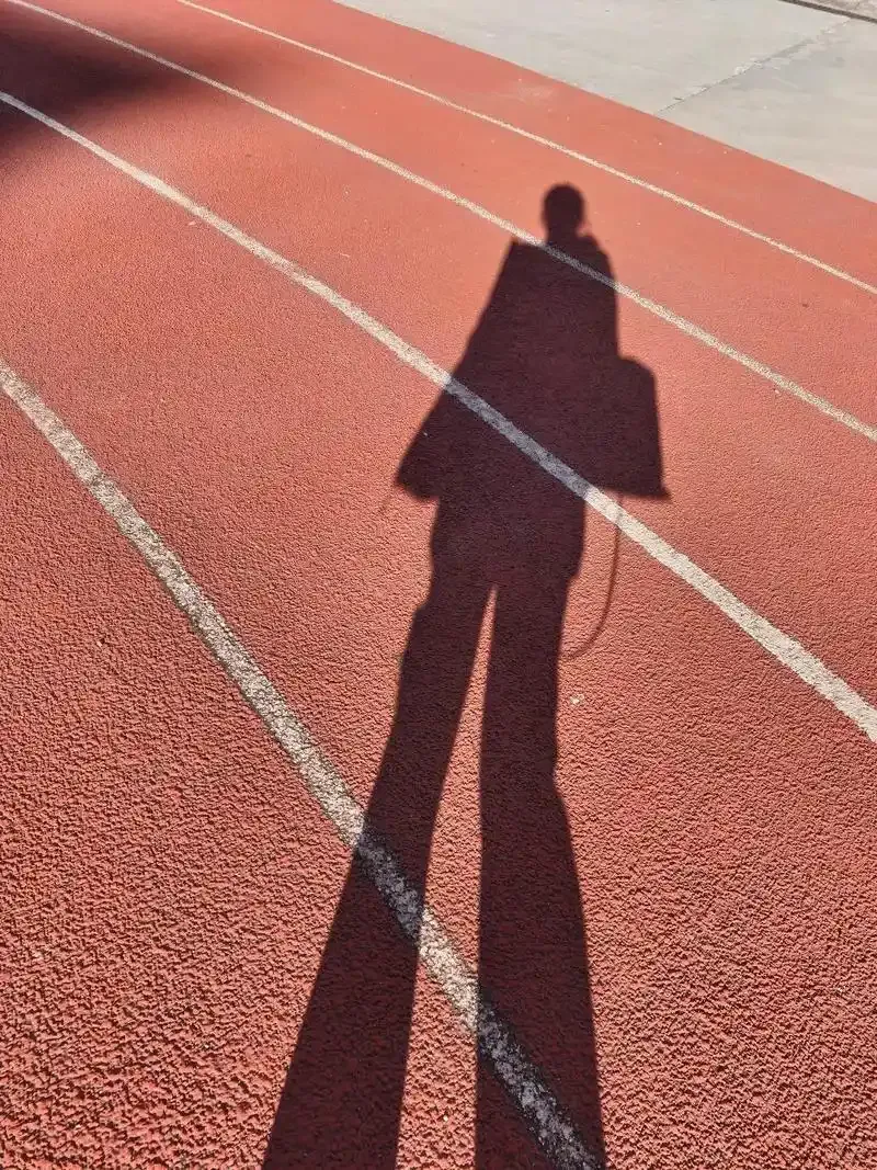 A long autumn shadow — read the light, not the thermometer, as summer turns to fall